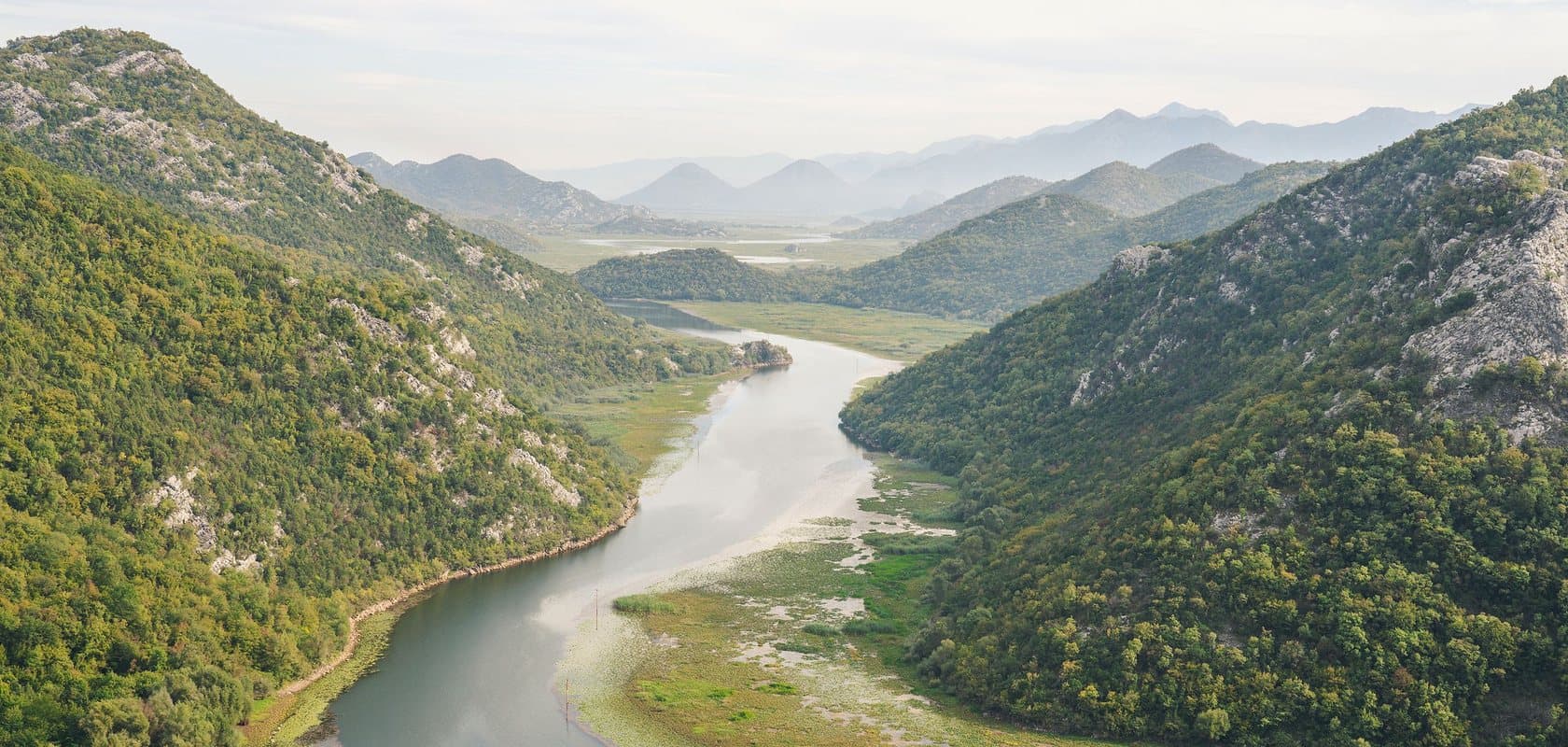 The Rijeka Crnojevica river looping through the green hills near Lake Skadar