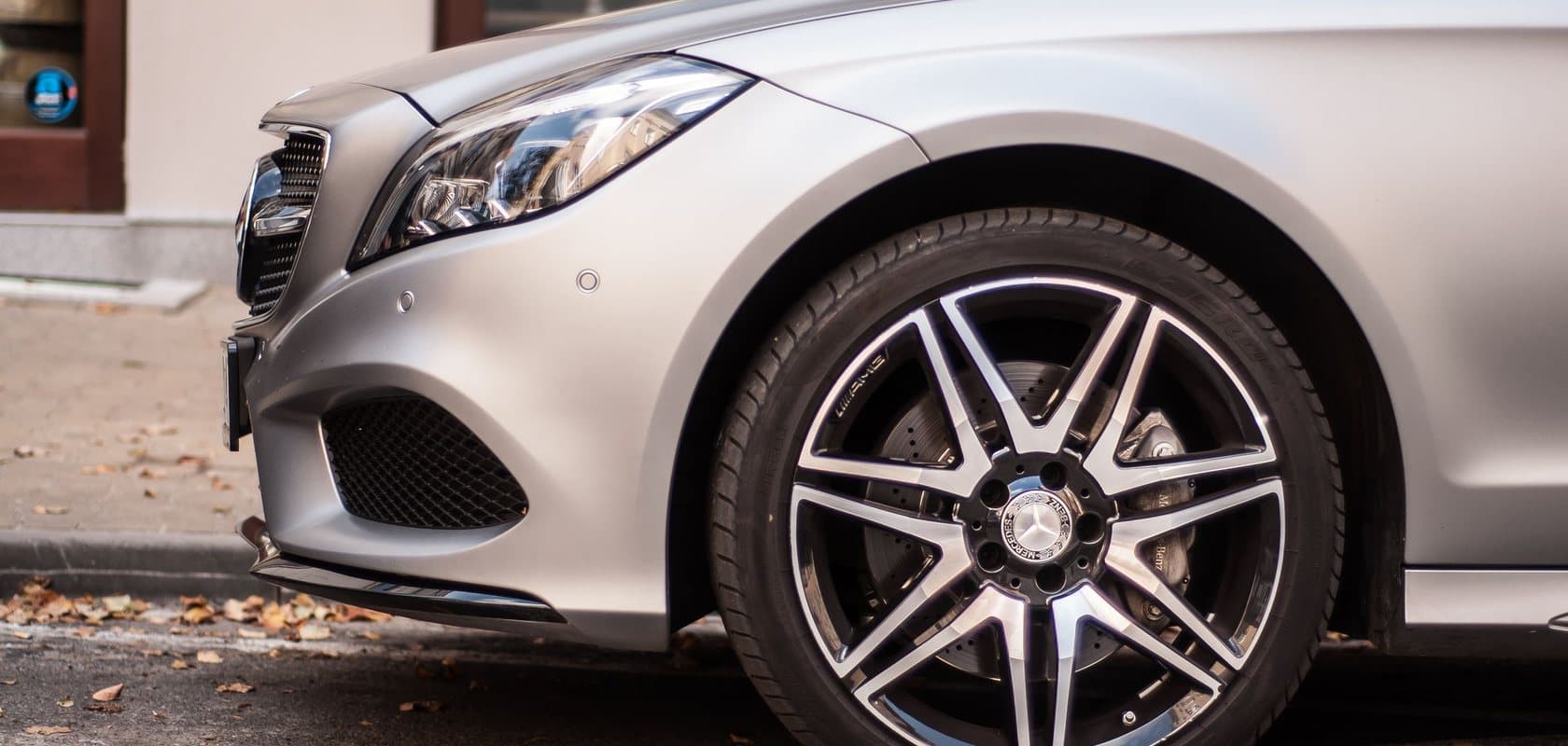 Close-up of a silver Mercedes front wheel and alloy during a handover walk-around