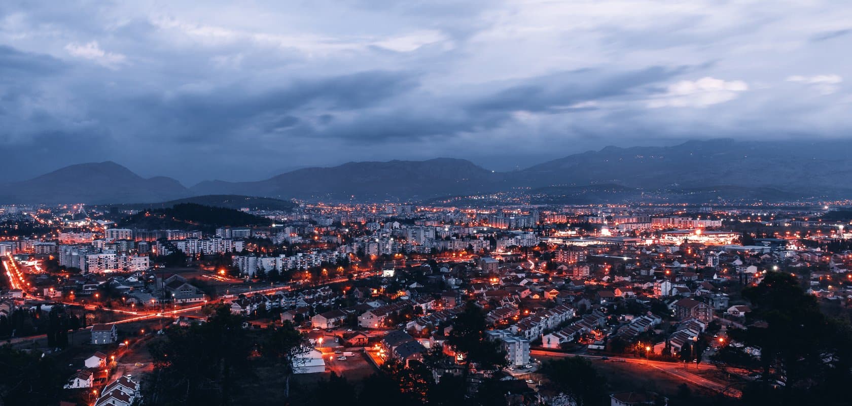 Podgorica lighting up at dusk, minutes from the airport